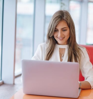 elegant-woman-with-smiling-face-typing-her-laptop